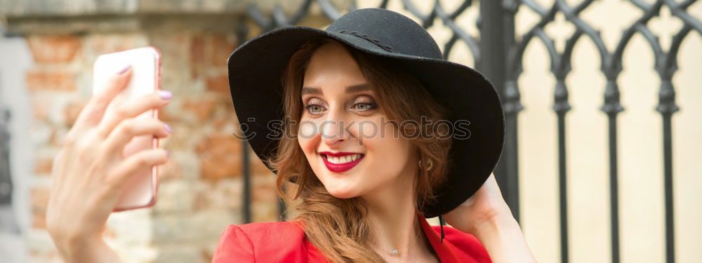 Similar – Beautiful Smiling Woman in red coat with mobile phone in hands, smartphone, urban scene