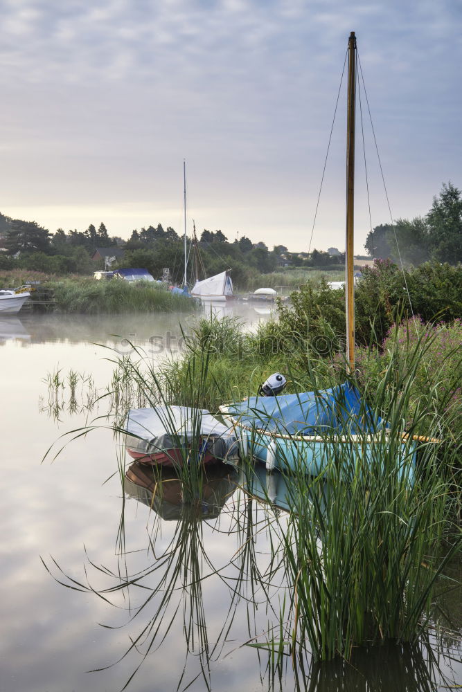 Similar – Image, Stock Photo Woman enjoying the evening sun with a colourful umbrella on a bench in the reeds by the lake