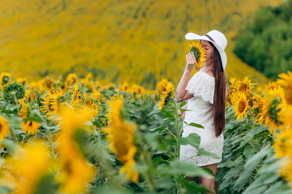 Similar – Image, Stock Photo Woman dressed in red sitting on a meadow and looking for something in her handbag