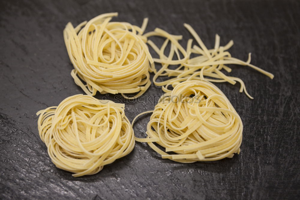 Similar – Raw tagliatelle on dark table