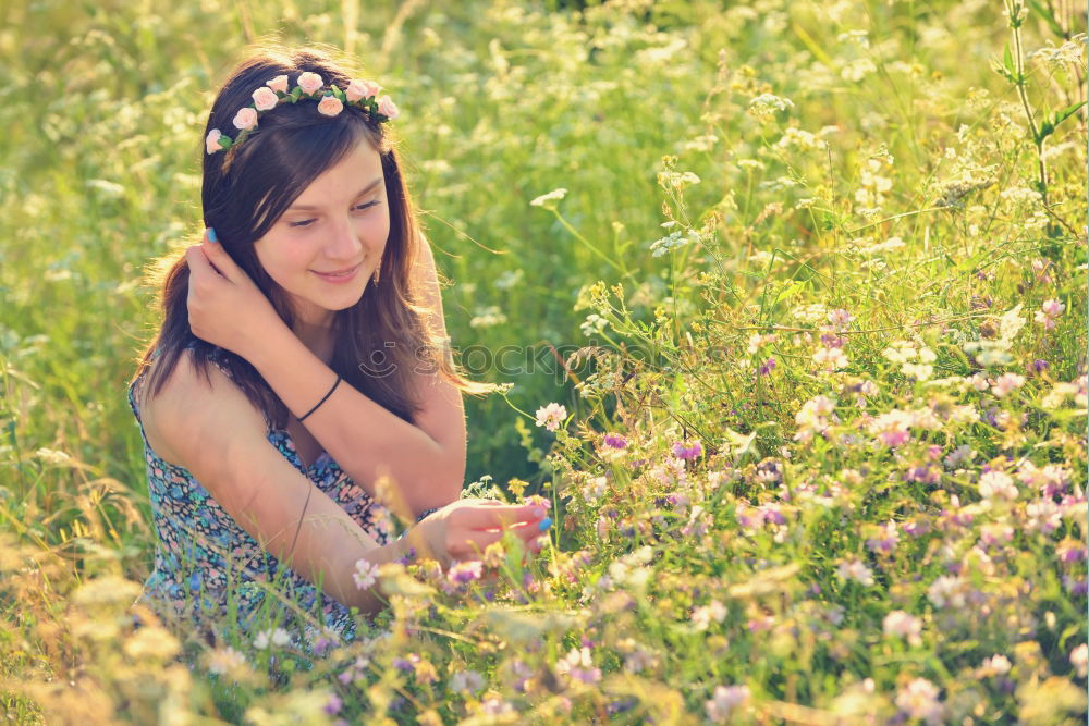 Similar – Image, Stock Photo Thoughtful young woman with bowed head on yellow meadow. Attractive girl with bowed head on a meadow of flowers in yellow to the horizon in the sunshine in spring or summer. Photo of a series.