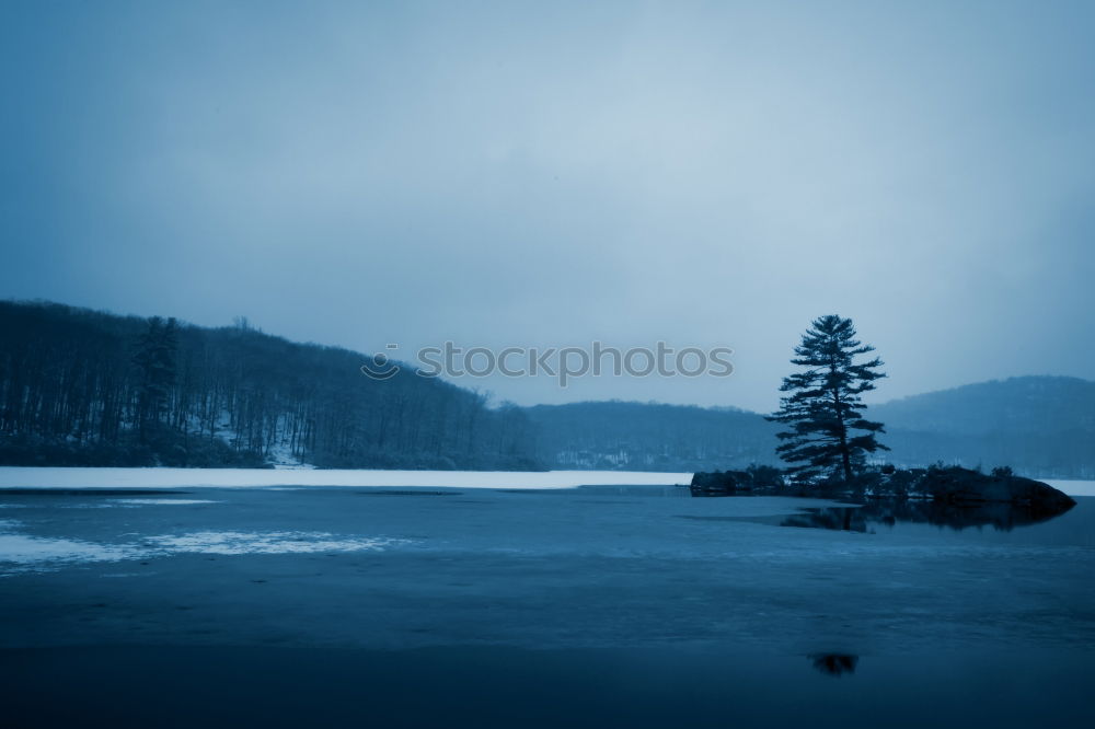 Similar – Half-frozen lake in idyllic winter landscape