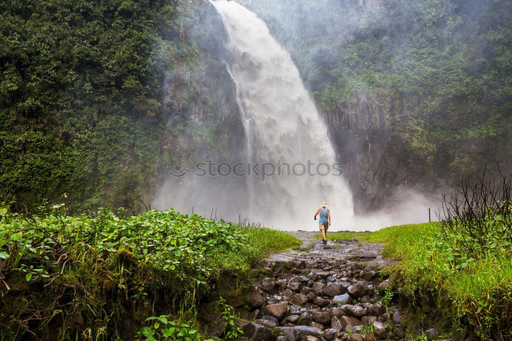 Similar – young woman standing in front of tropical waterfall