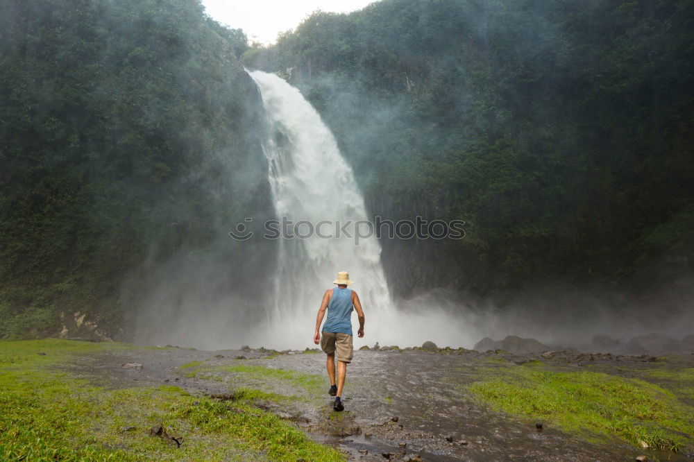 Similar – young woman standing in front of tropical waterfall