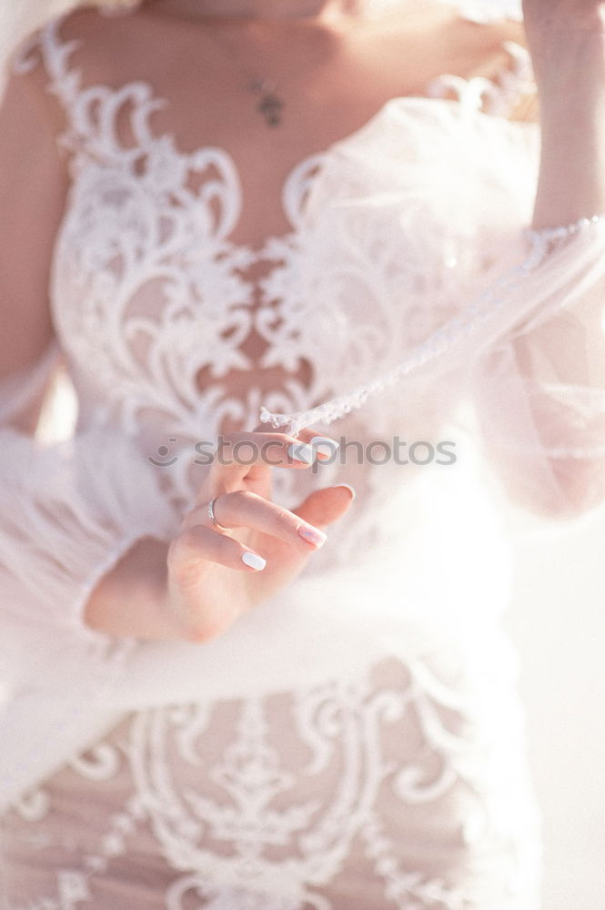 Similar – beautiful young woman with long flowing blond hair examines white wedding dress