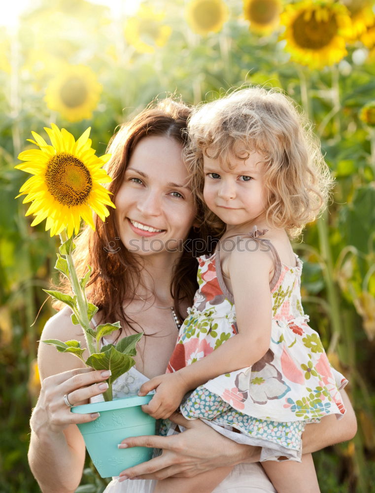 Similar – Image, Stock Photo Young happy mother embraced her cute little girl at canola field