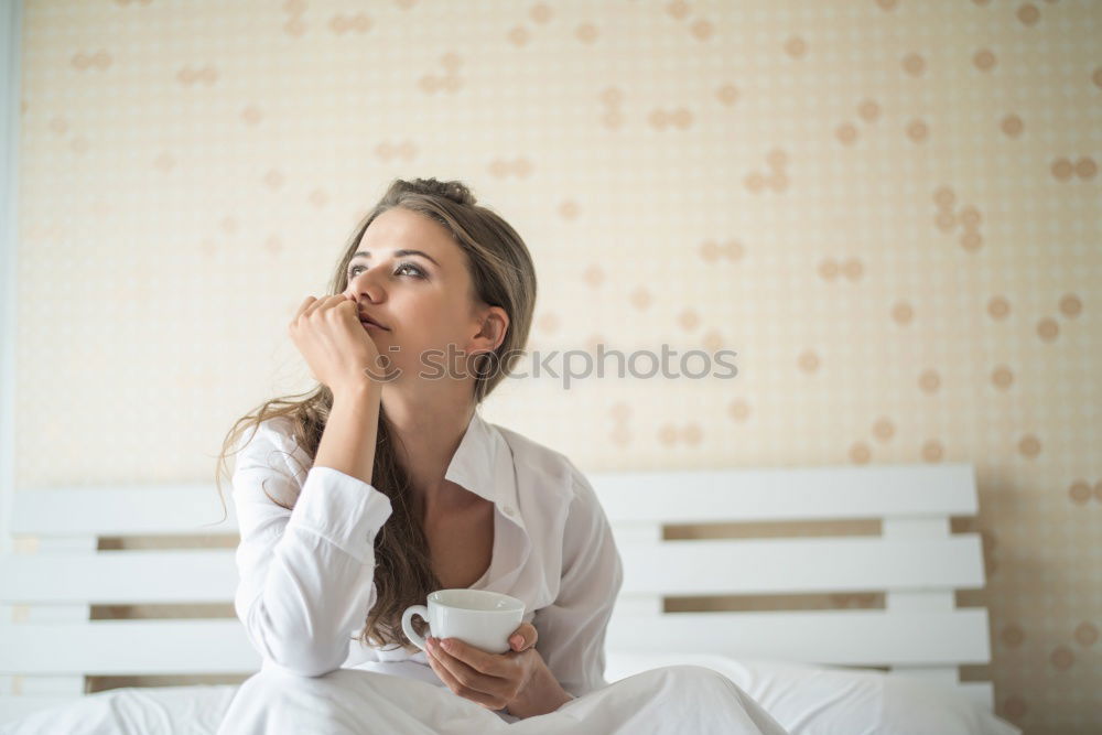 Similar – young tall woman sits on a light couch