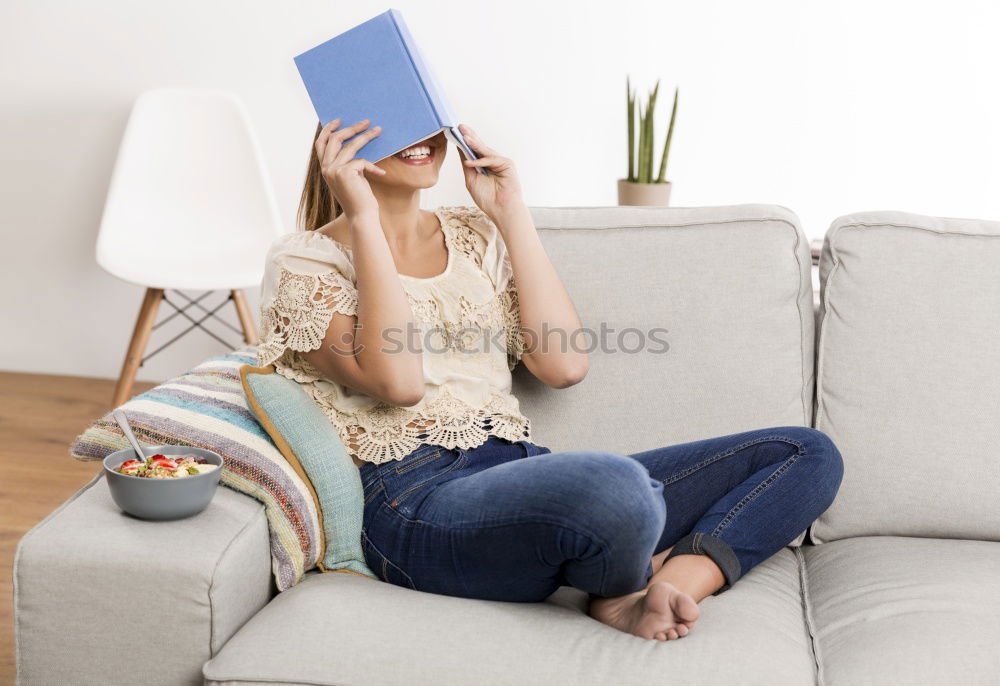 Similar – black woman reading on a sofa