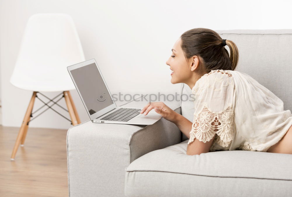 Similar – woman with laptop on her sofa at home