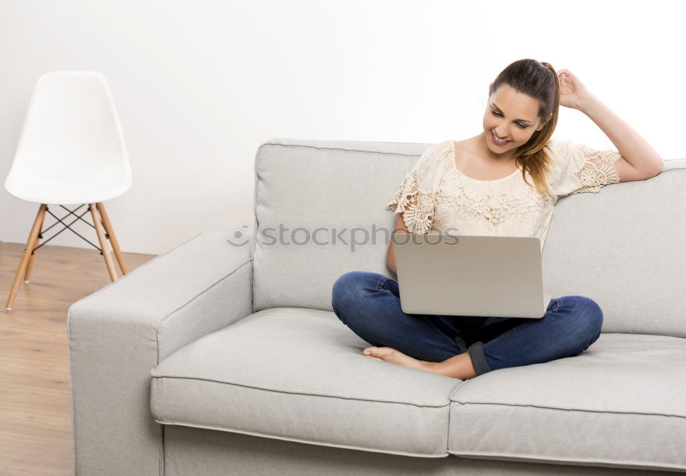 Similar – woman with laptop on her sofa at home