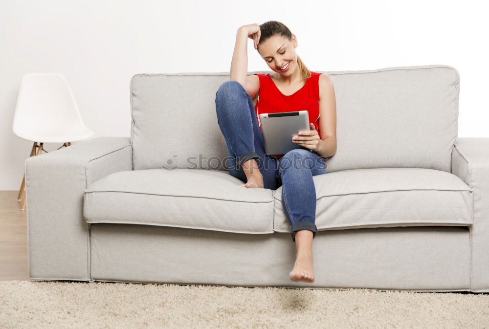 Similar – young tall woman sits on a light couch