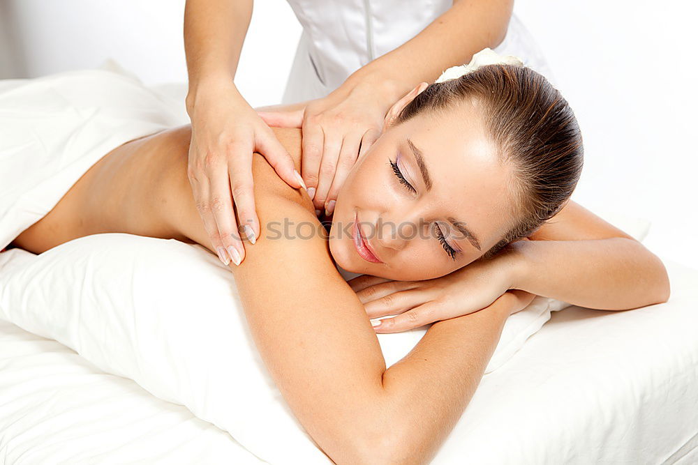 Similar – Young blond woman receiving a head massage in a spa center