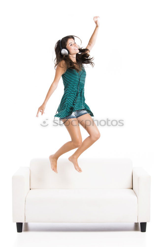 Similar – Long haired girl in jeans jumps headfirst into a sofa