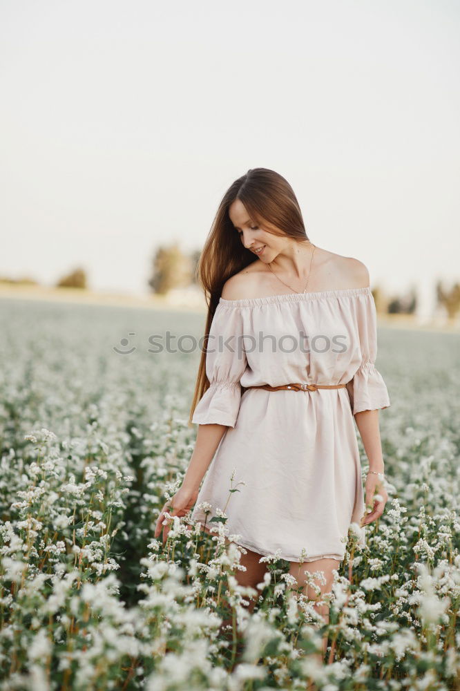 Similar – young hooded woman in a white sweatshirt with a serious look