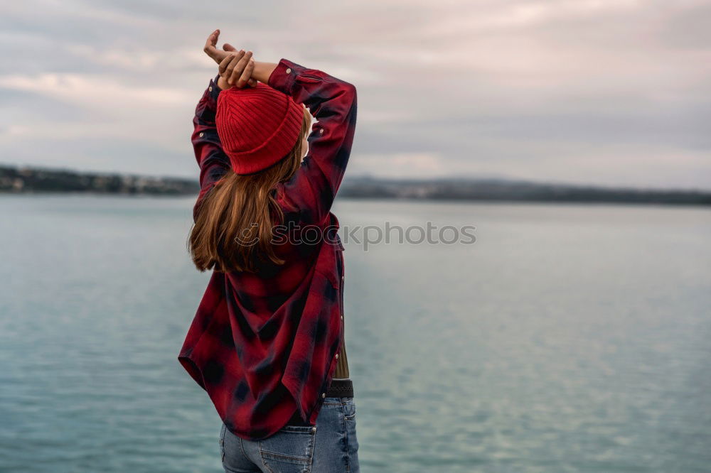 Similar – Image, Stock Photo Young woman is taking picture of sunset at the beach