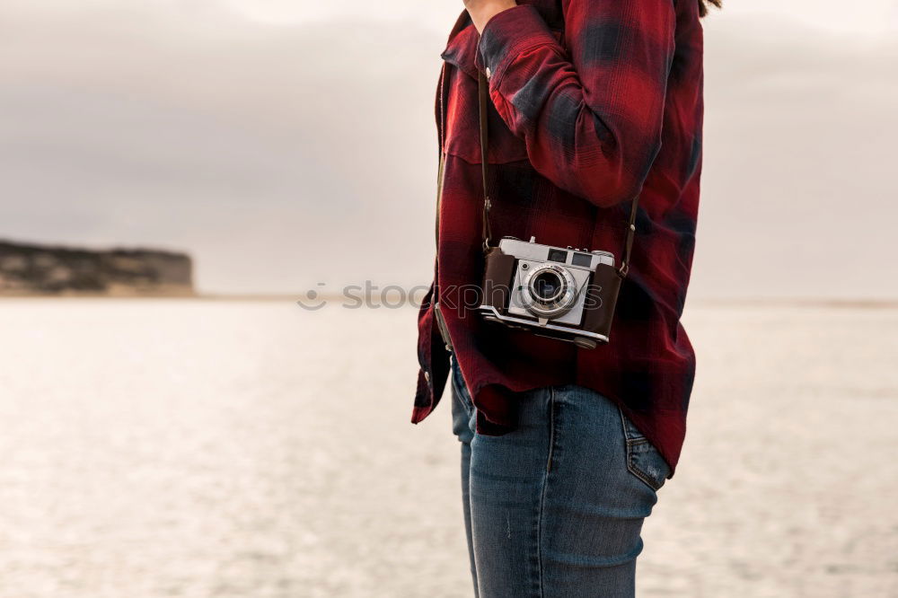 Similar – Image, Stock Photo Lady with camera on shore near stones and water