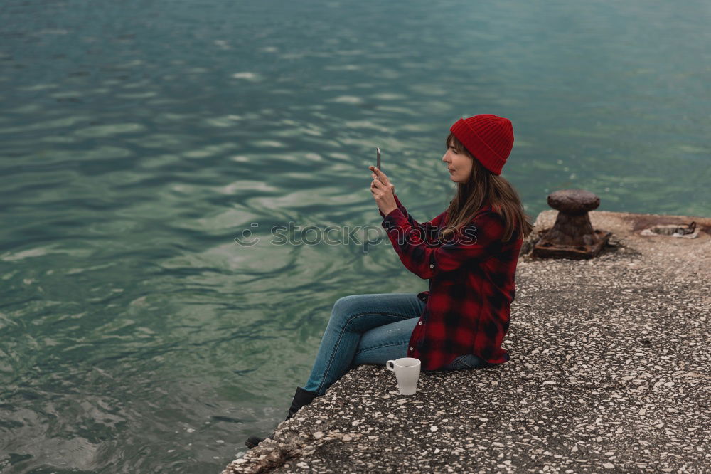 Similar – Woman looking out through a bridge, with a hand floating in the air.