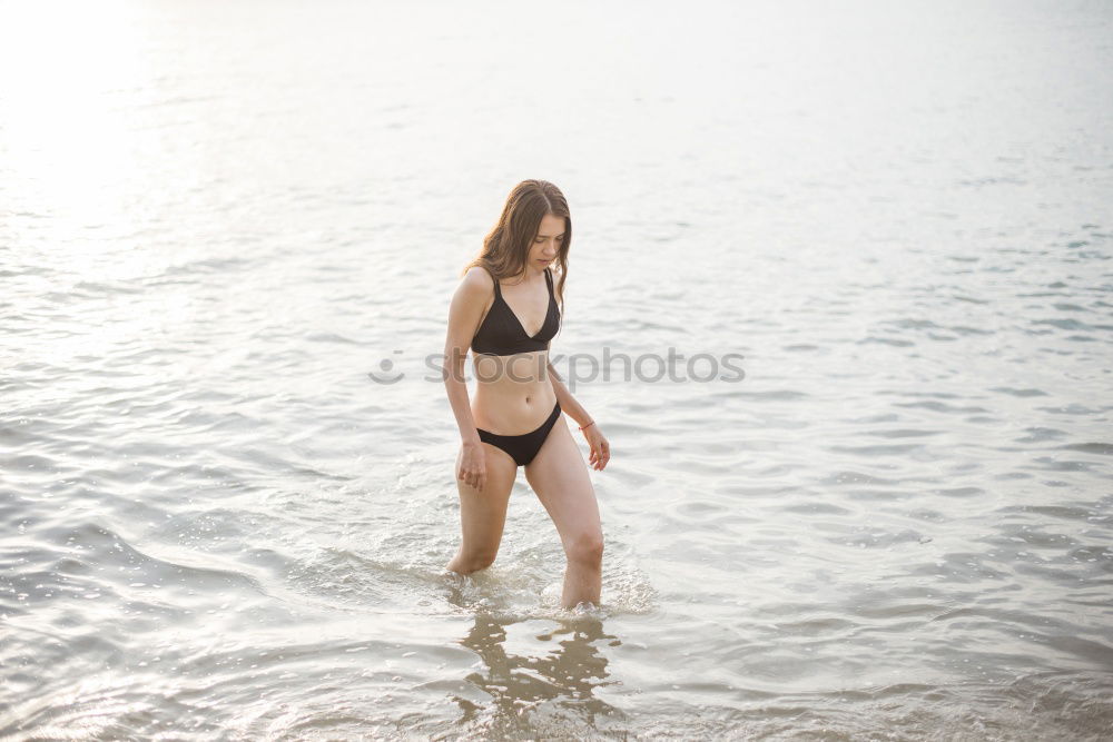 Similar – Beautiful young woman in sexy bikini standing at sea beach. Beautiful woman in violet bikini on tropical beach. Portrait of brunette tanned girl in swimwear