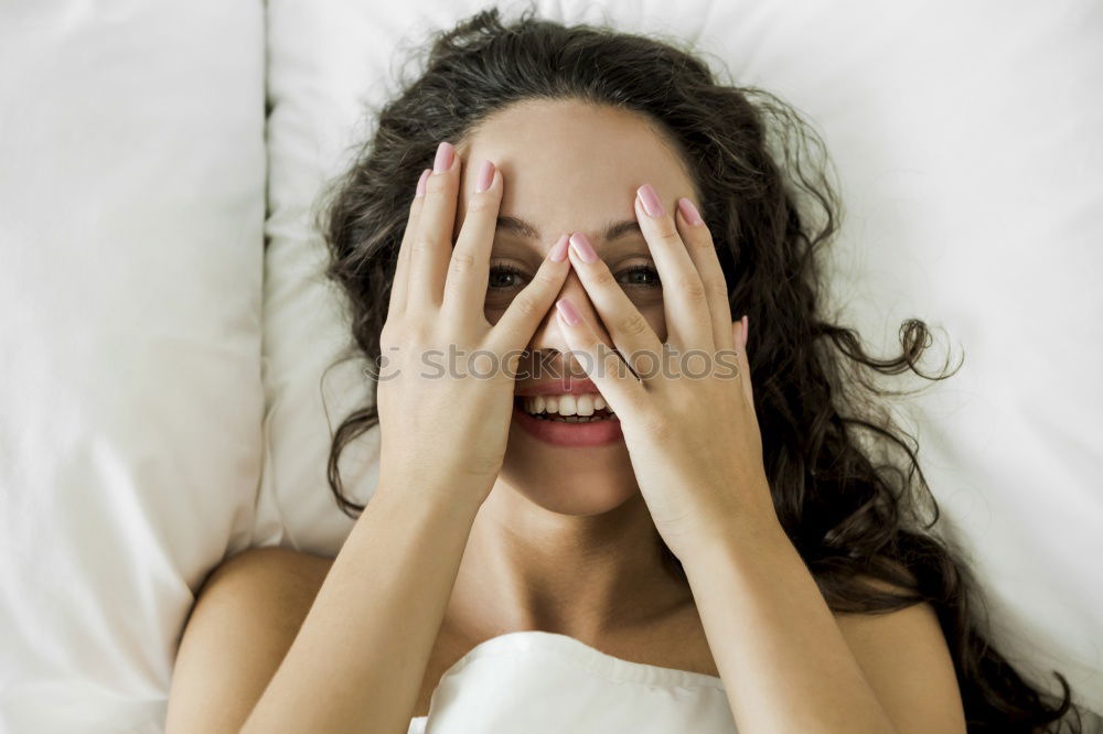 Similar – Portrait of an attractive, young, sexy dark haired woman in Bed, hand and head on the pillow under the blanket, Copy space.