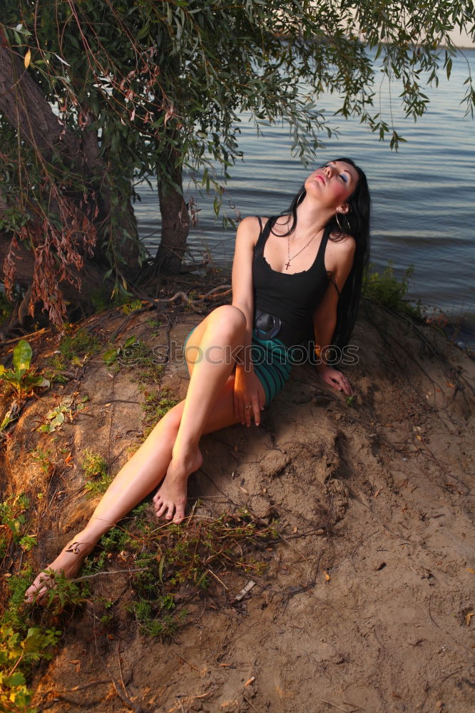 Similar – Image, Stock Photo Young tattooed woman with turquoise hair sits barefoot in beach forest leaning against tree and smiles at camera