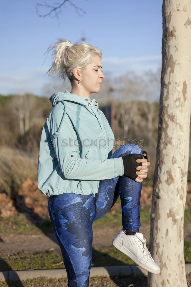 Similar – Image, Stock Photo blonde woman sitting in the grass and stretching in a park