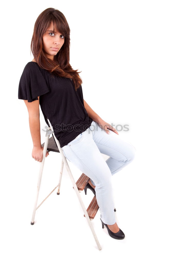 Similar – Elegant businesswoman looking at camera while sitting on stairs against of white wall