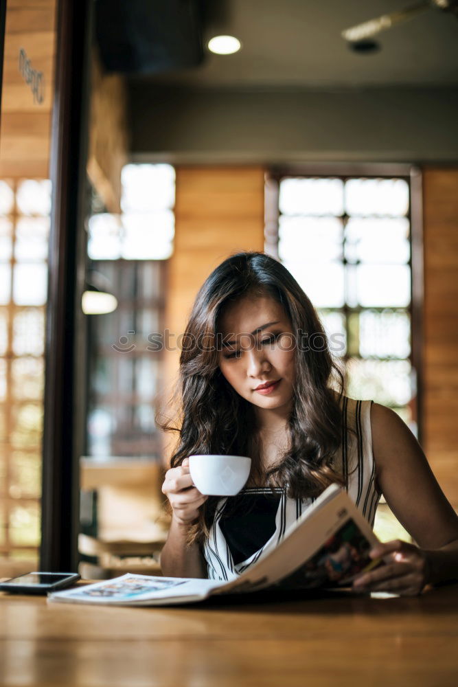 Similar – Young businesswoman working on laptop and drinking coffee