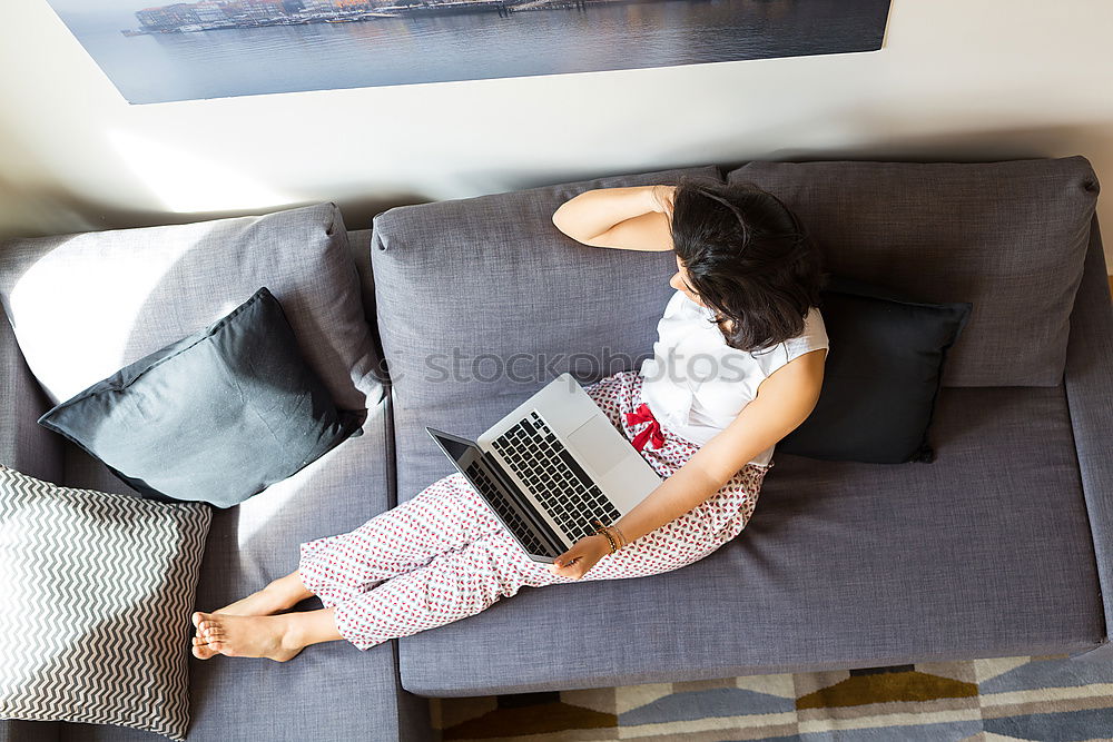 Similar – Mature woman sitting on couch at modern home