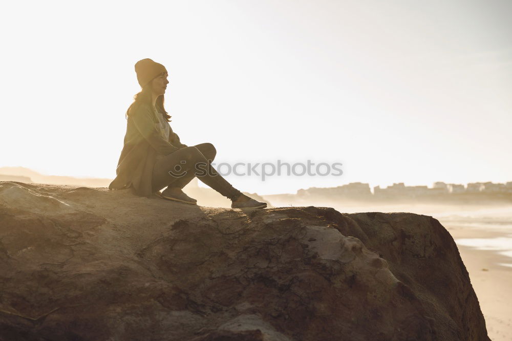 Similar – Image, Stock Photo Young woman is taking picture of sunset at the beach