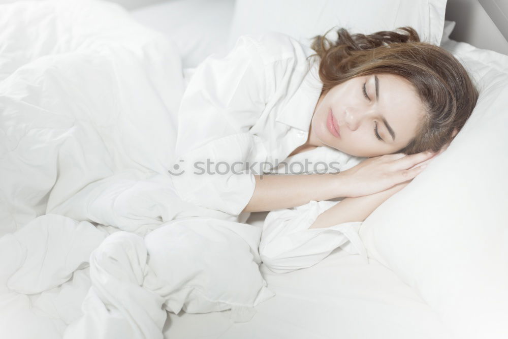 Similar – Image, Stock Photo A young smiling beautiful girl is lying in bed in the bedroom. The girl stretches in the morning after waking up. Side view, space for text