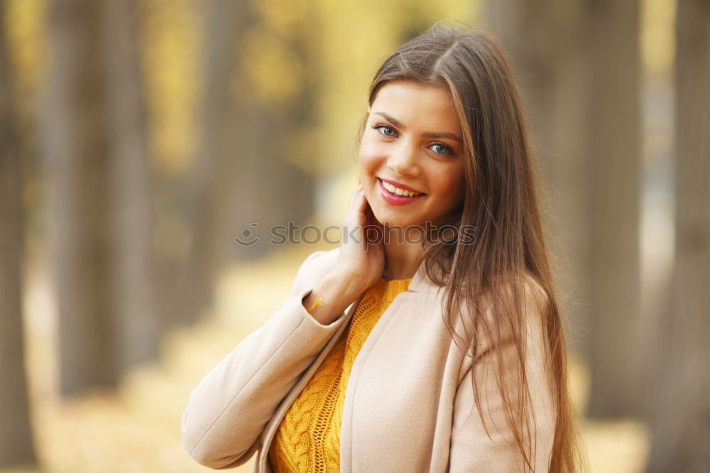 Similar – Image, Stock Photo Smiling young woman chatting on a mobile in autumn