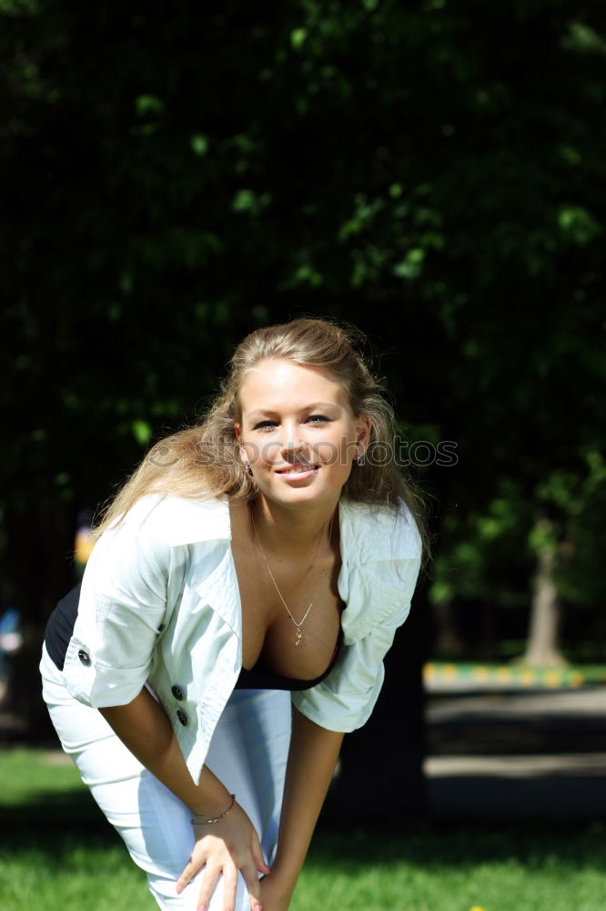 Similar – Young tall blonde woman standing on balcony barefoot in the sun leaning against brick wall and smiling at camera