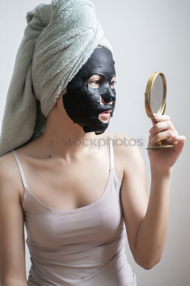 Similar – Image, Stock Photo Woman with bathrobe and towel on her head enjoys a face mask and holds two slices of cucumber in front of her eyes. Wellness, face care.