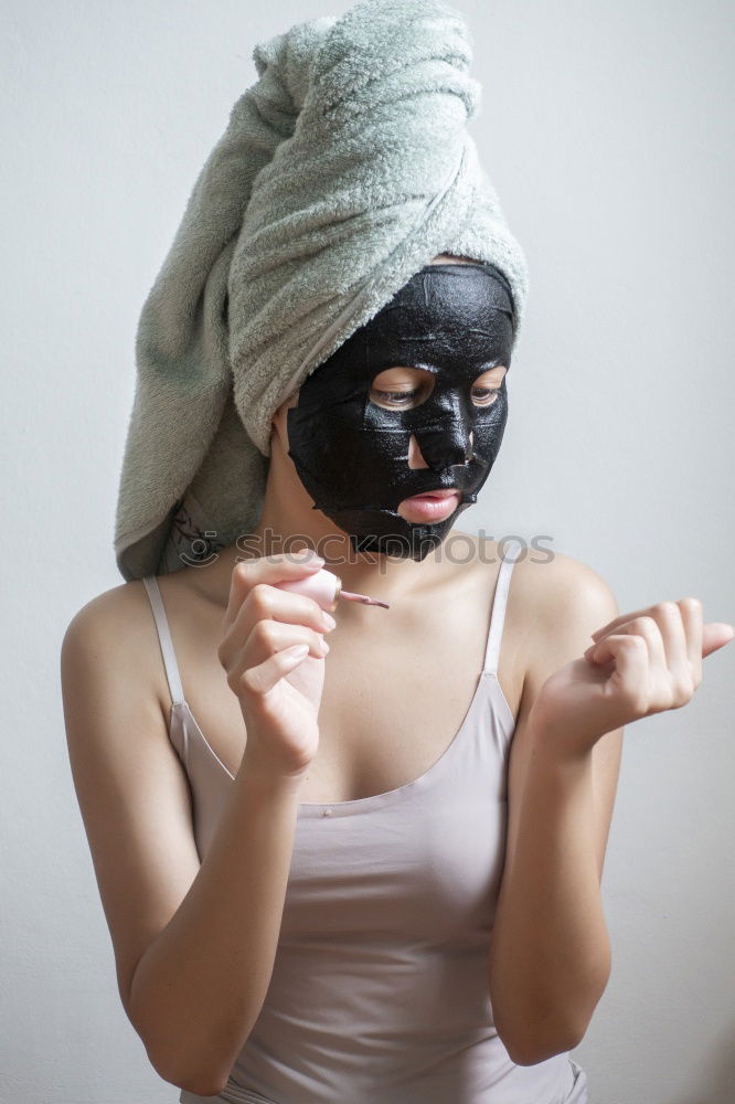 Similar – Image, Stock Photo Woman with bathrobe and towel on her head enjoys a face mask and holds two slices of cucumber in front of her eyes. Wellness, face care.