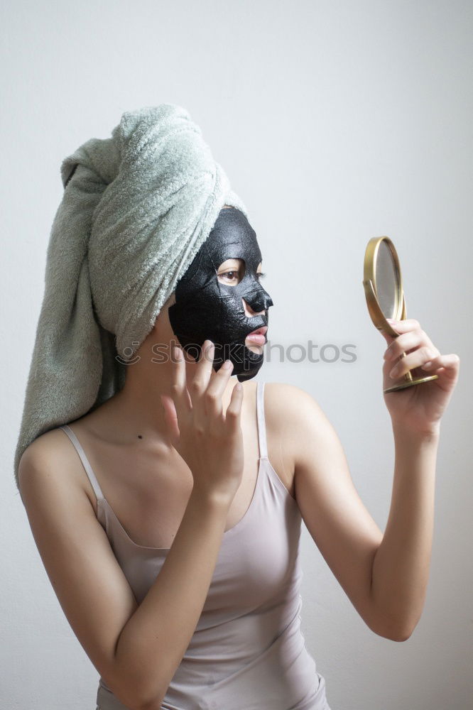 Similar – Image, Stock Photo Woman with bathrobe and towel on her head enjoys a face mask and holds two slices of cucumber in front of her eyes. Wellness, face care.