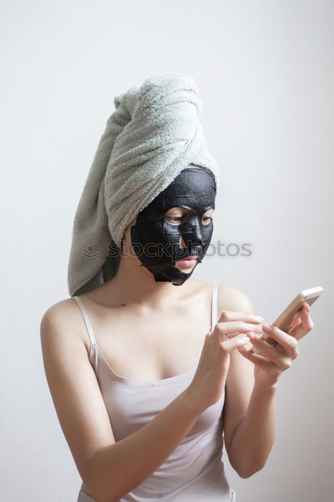 Similar – Image, Stock Photo Woman with bathrobe and towel on her head enjoys a face mask and holds two slices of cucumber in front of her eyes. Wellness, face care.