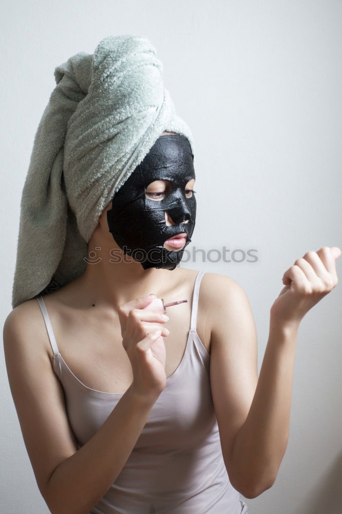 Similar – Image, Stock Photo Woman with bathrobe and towel on her head enjoys a face mask and holds two slices of cucumber in front of her eyes. Wellness, face care.