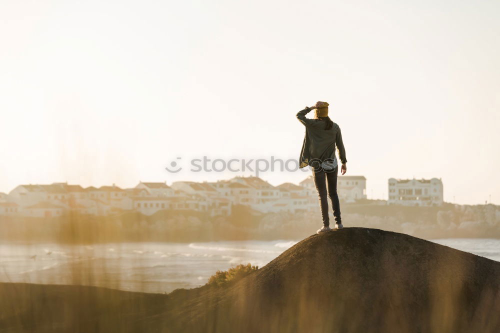 Similar – Man with tattoos holding skateboard at shore. Back view.