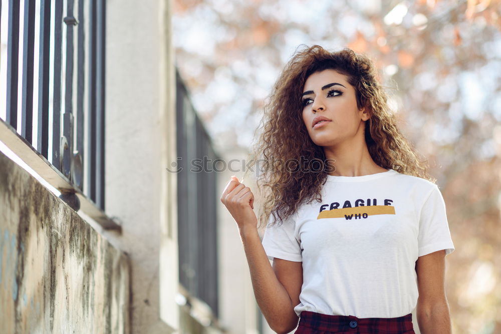 Similar – Young woman curly hairstyle with casual clothes in the street