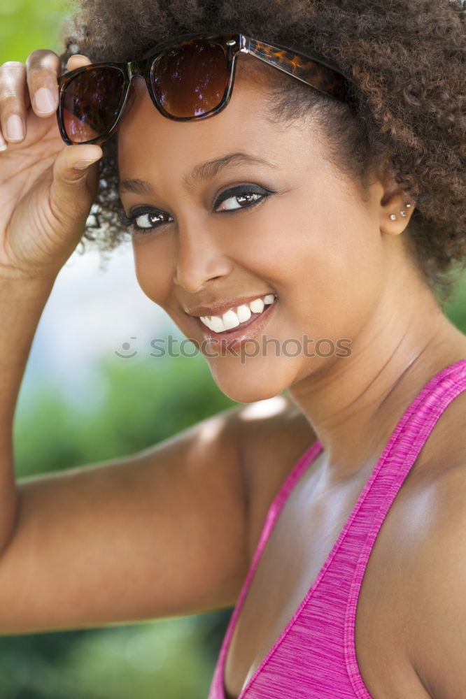 Similar – Young black woman with afro hairstyle smiling in urban park