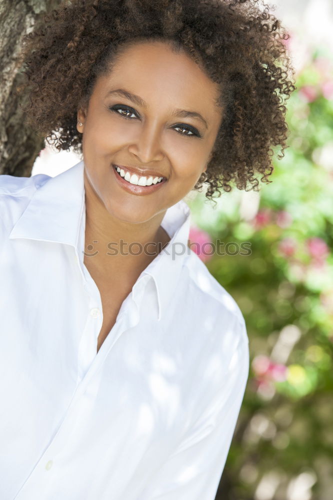 Similar – Young woman smiling with afro hairstyle and green eyes