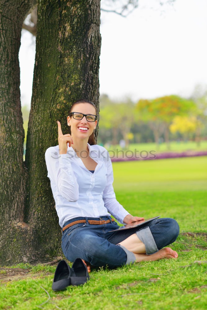 Similar – Front view of a young hipster woman sitting on a park bench relaxing in a sunny day while looking away