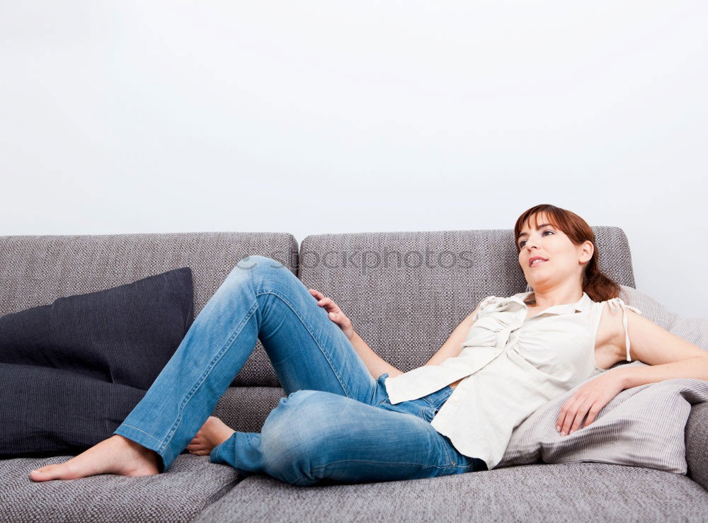 Similar – young tall woman sits on a light couch