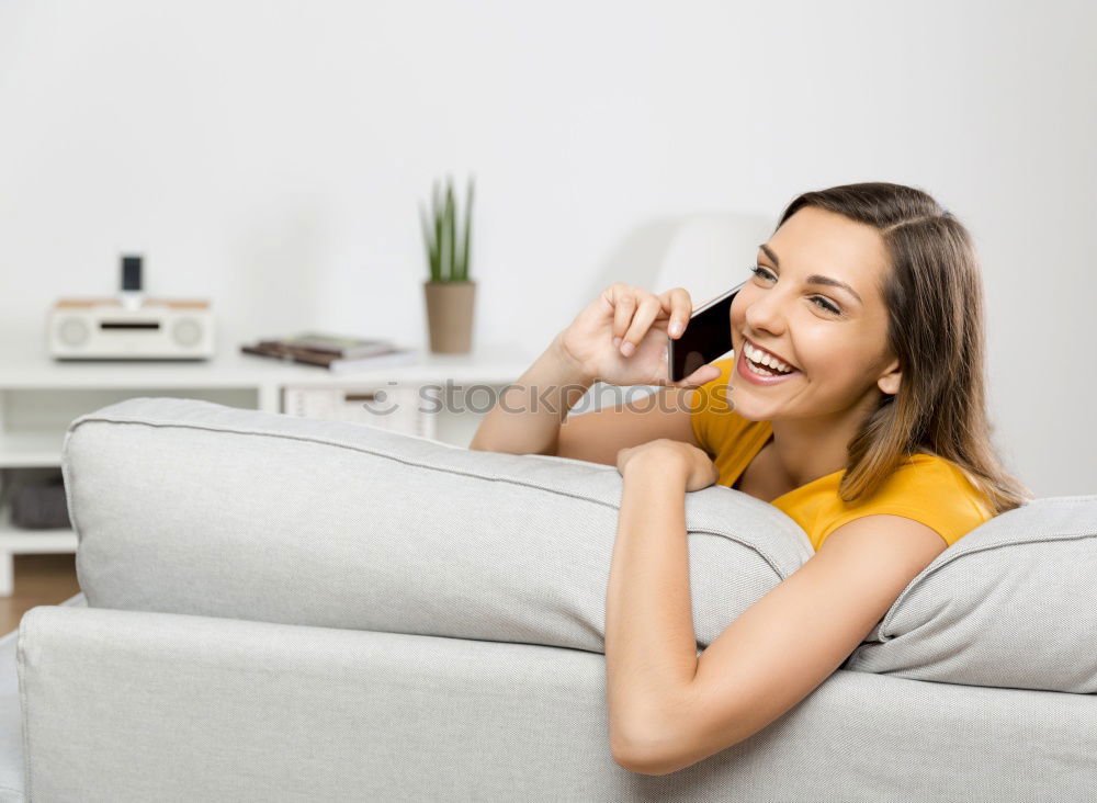 Similar – young tall woman sits on a light couch