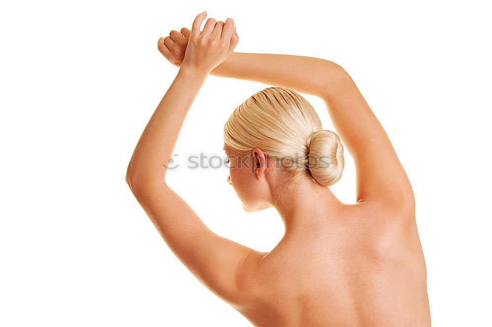 Similar – young woman with very short hair stands naked in front of light turquoise wall in pose with half raised arms