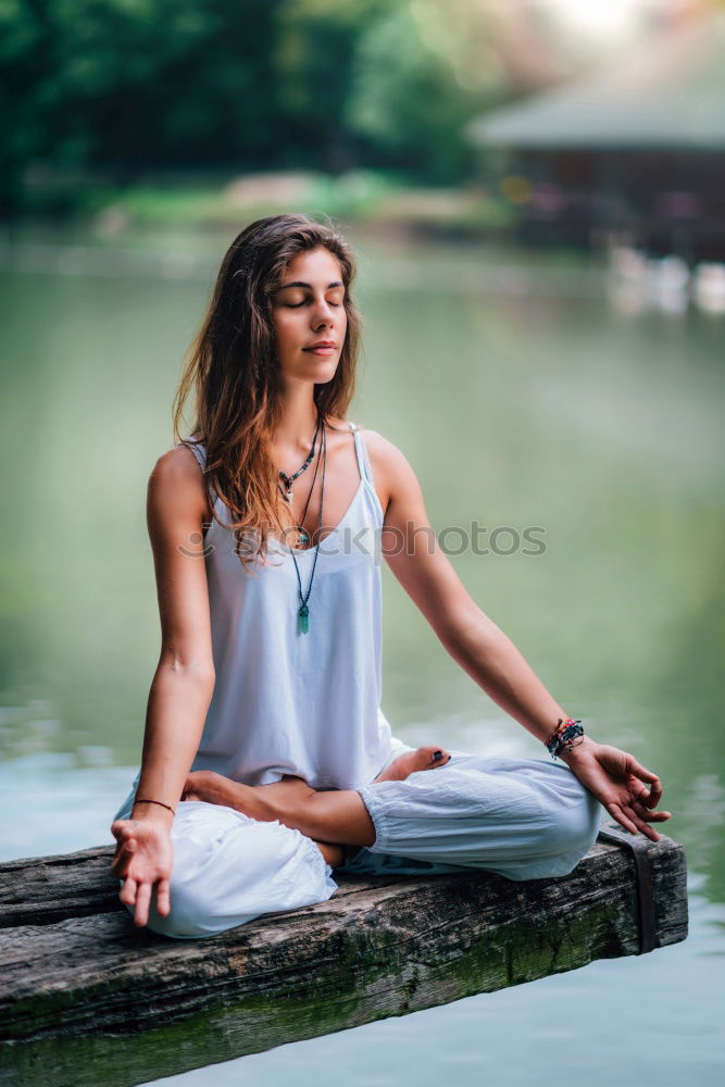 Similar – Young woman meditates in yoga asana Padmasana