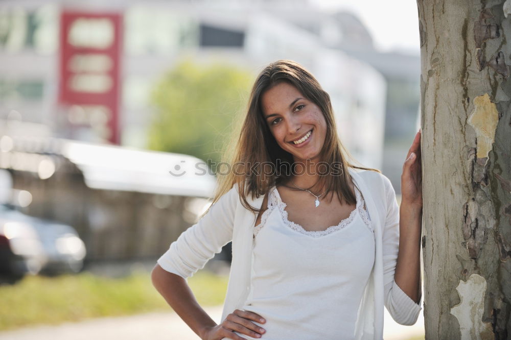 Similar – sad young woman leaning against tree