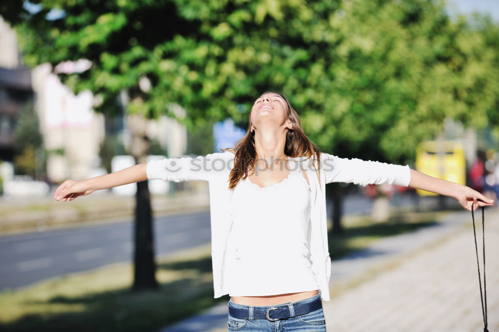 Similar – Winter ideas. Beautiful young girl stretching her finger upwards while snowing on a green meadow.