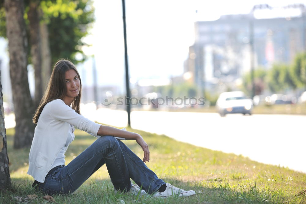 Similar – thoughtful woman with dreadlocks, in jeans and brown leather jacket is standing at an old dilapidated house wall