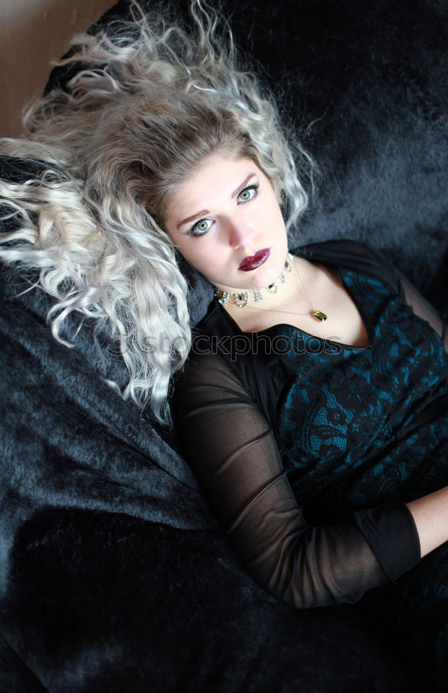 Similar – Image, Stock Photo Young, redheaded woman lies on a flowered sofa and looks sideways into the camera